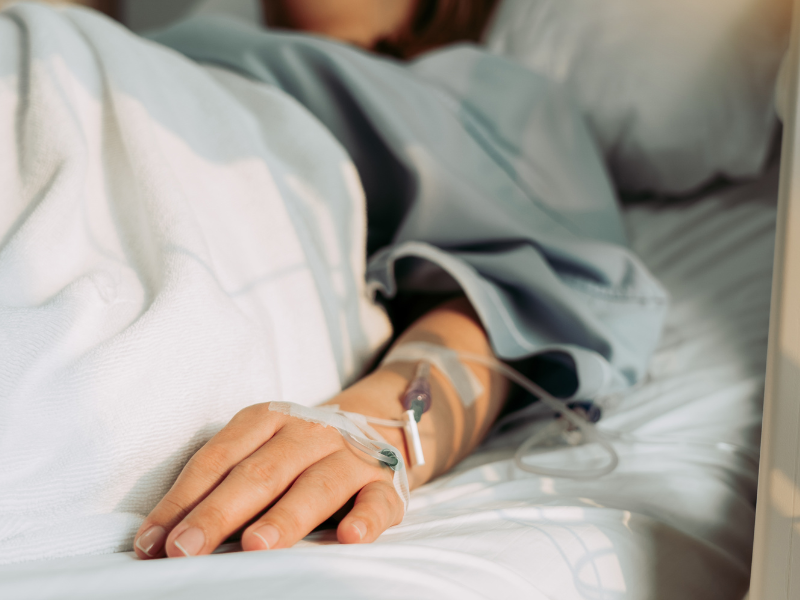 Woman with Iv drip in bed after getting Bali belly