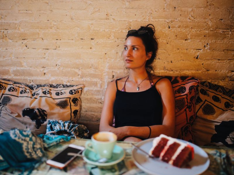 Girl in a cafe pondering, can you drink the water in bali? 