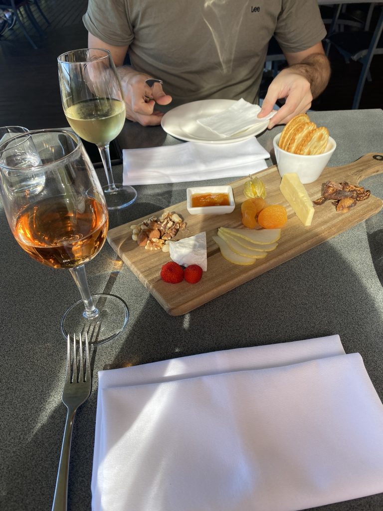 Enjoying a flame hill cheese platter and a glass of Rose