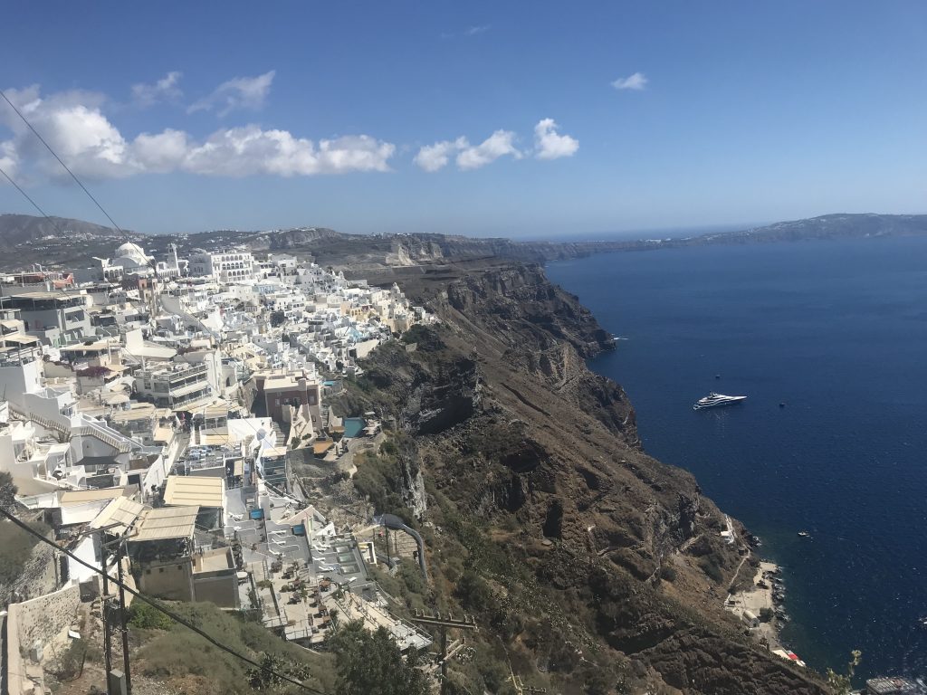 Stunning views of Santorini showcasing the cliffs and crystal clear waters