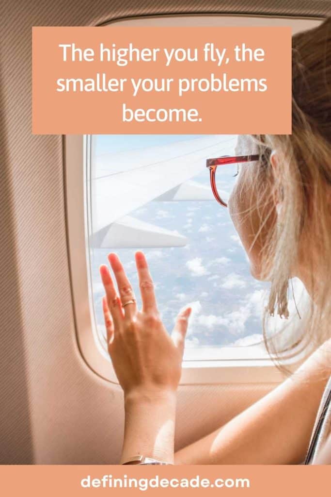 A girl in a plane with the caption: The higher you fly, the smaller your problems become